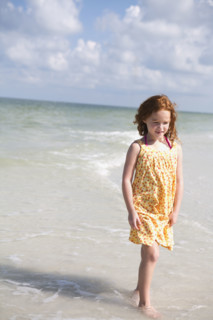 Girl walking through ocean surf. Date : 2008