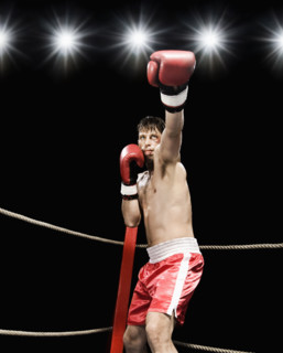 Boxer extending arm in boxing ring. Date : 2008