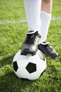 Close up of boy’s foot on soccer ball. Date : 2008