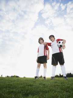 Portrait of boys in soccer uniforms holding ball. Date : 2008