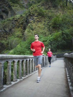 Couple running across bridge. Date: 2008
