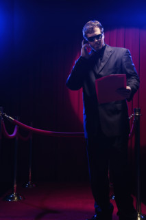 Bouncer looking at guest list. Date: 2008