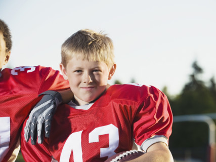 Football player posing on field. Date: 2008