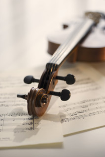 Violin laying on sheet music.