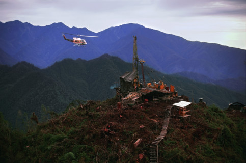 Helicopter flying over oil drilling platform in Indonesia. Date : 2008