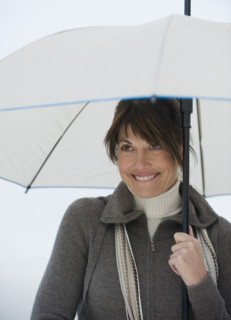 Woman with umbrella smiling.