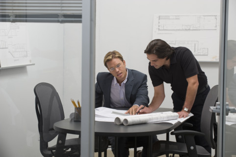 Architects reviewing blueprints.