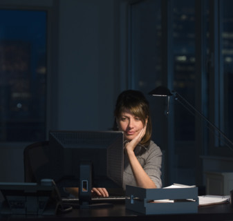 Businesswoman working late in office.