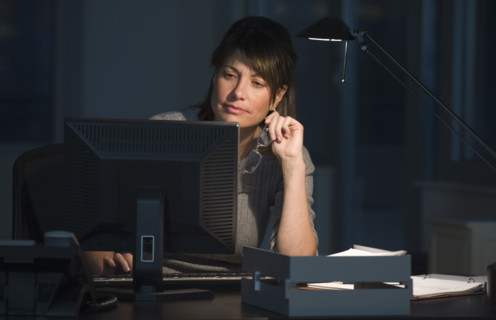 Businesswoman working late in office.