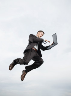Businessman with laptop n mid-air. Date : 2008