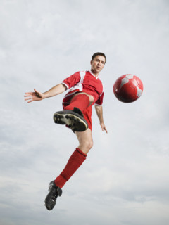 Soccer player kicking soccer ball in mid-air. Date : 2008