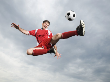 Soccer player kicking soccer ball in mid-air. Date : 2008