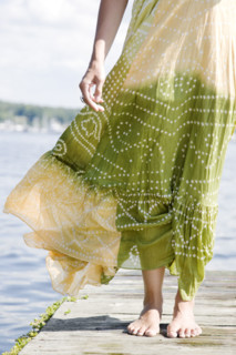 Wind blowing dress of woman standing on dock. Date : 2008