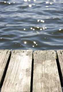 Close up of dock and sun reflecting on lake. Date : 2008