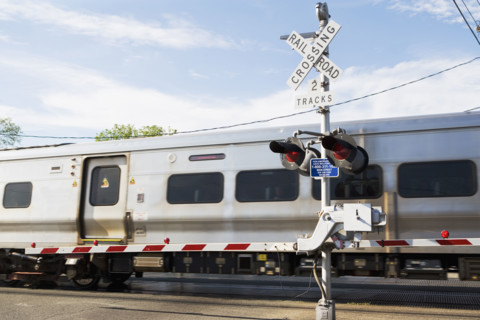 Commuter train moving through railroad crossing. Date : 2008