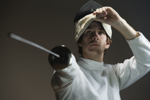 Man pointing fencing foil and lifting mask. Date : 2008