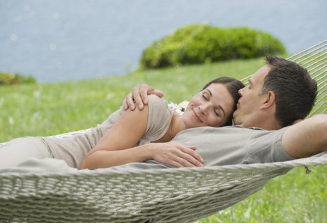 Couple laying in hammock.