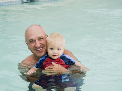 Grandfather and grandson posing in swimming pool. Date : 2008