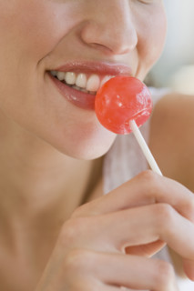 Close up of woman with lollipop.