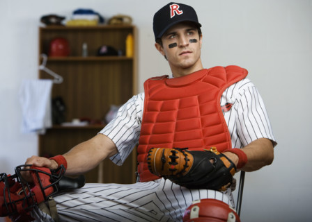 Baseball catcher sitting in locker room looking pensive. Date : 2008