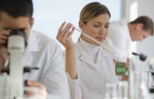 Scientists experimenting in pharmaceutical laboratory.