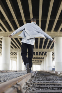 Man balancing on railroad tracks. Date : 2008