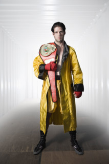 Boxer in robe posing with championship belt. Date : 2008