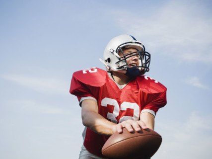Quarterback holding football. Date: 2008