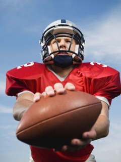 Quarterback holding football. Date: 2008