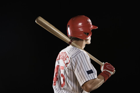 Baseball player standing with bat. Date : 2008