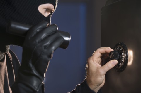 Burglar cracking safe.