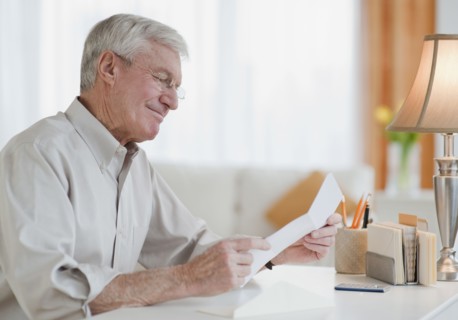 Senior man reading letter.