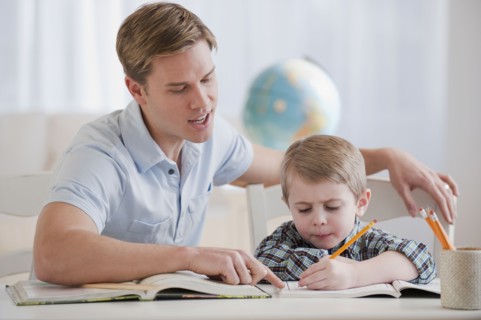 Father helping son with homework.