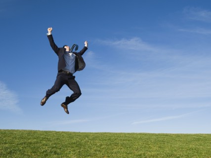 Businessman jumping in air.