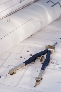Drawing compass and blueprints. Photographe : Daniel Grill