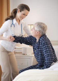 Nurse helping senior man out of man.