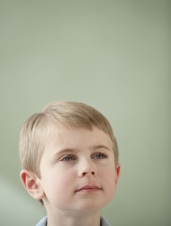 Portrait of boy looking up.