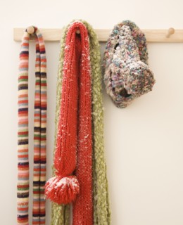 Snowy scarves hanging on rack. Photographe : Jamie Grill