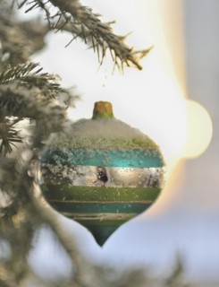 Close up of snow covered Christmas ornament.
