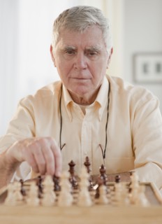 Senior man playing chess.