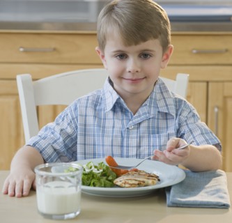 Boy eating dinner.