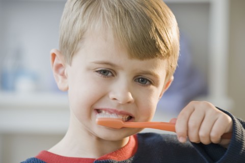 Boy brushing teeth.