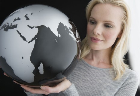 Woman holding modern globe.