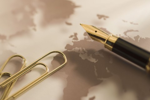 Gold paper clips and pen.
