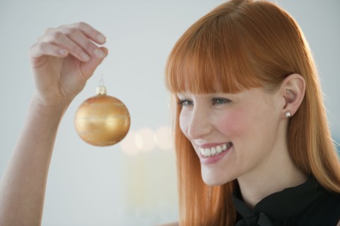 Woman holding Christmas ornament.