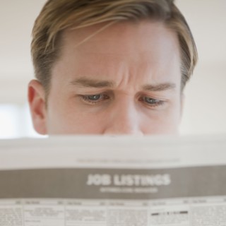 Man reading job listings.