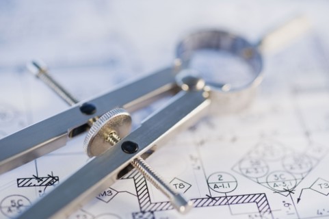 Drawing compass and blueprints. Photographe : Daniel Grill