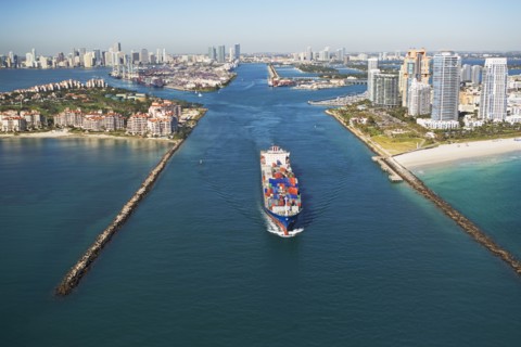 Aerial view of waterfront city and cargo ship. Photographe : fotog