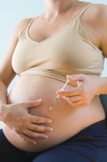Pregnant woman injecting belly. Photographe : Jennifer L. Boggs