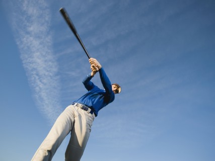 Baseball player swinging bat.